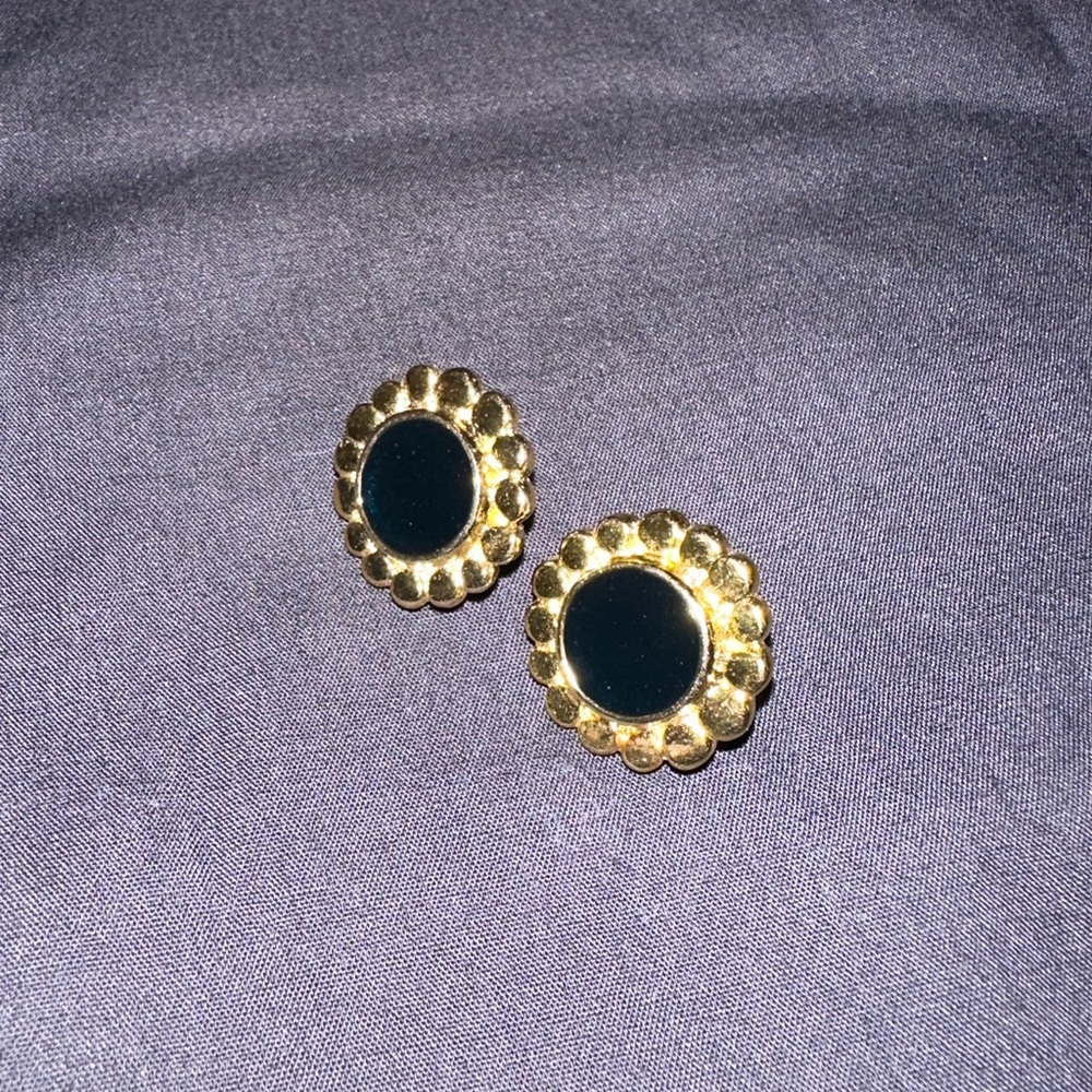 Gold and black earrings .